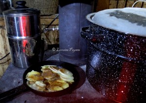Cooking dinner next to canner full of hot water